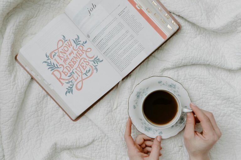 a person having coffee while reading a book