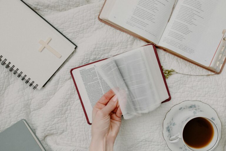 person holding white book page